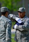Senior Airman Alex Ventura, 436th Civil Engineer Squadron structural journeyman, right, dresses the flag while Staff Sgt. Leopoldo Lardizabal, 436th CES structural craftsman, left, looks on during a retreat ceremony May 8, 2015, at Dover Air Force Base, Del. Retreat ceremonies are held on Fridays during the summer months and are conducted by different units on base. (U.S. Air Force photo/Airman 1st Class William Johnson)