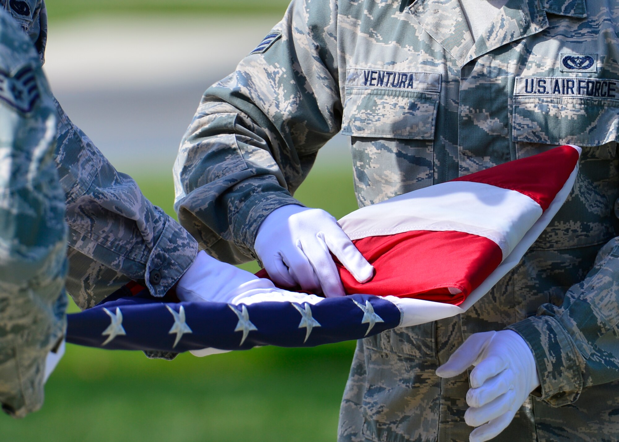 Senior Airman Alex Ventura, 436th Civil Engineer Squadron structural journeyman, folds the flag during a retreat ceremony May 8, 2015, at Dover Air Force Base, Del. This was the first retreat ceremony of the year and they will continue to be conducted every Friday. (U.S. Air Force photo/Airman 1st Class William Johnson)