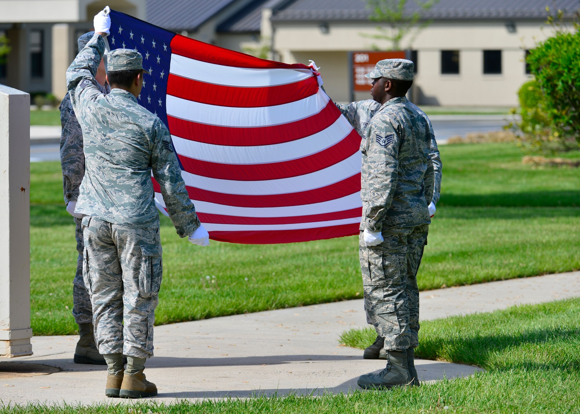 Staff Sgt. Leopoldo Lardizabal, 436th Civil Engineer Squadron structural craftsman, left, and Senior Airman Alex Ventura, 436th CES structural journeyman, right, display the colors during a retreat ceremony May 8, 2015, at Dover Air Force Base, Del. The security flag detail was from the 436th CES. (U.S. Air Force photo/Airman 1st Class William Johnson)