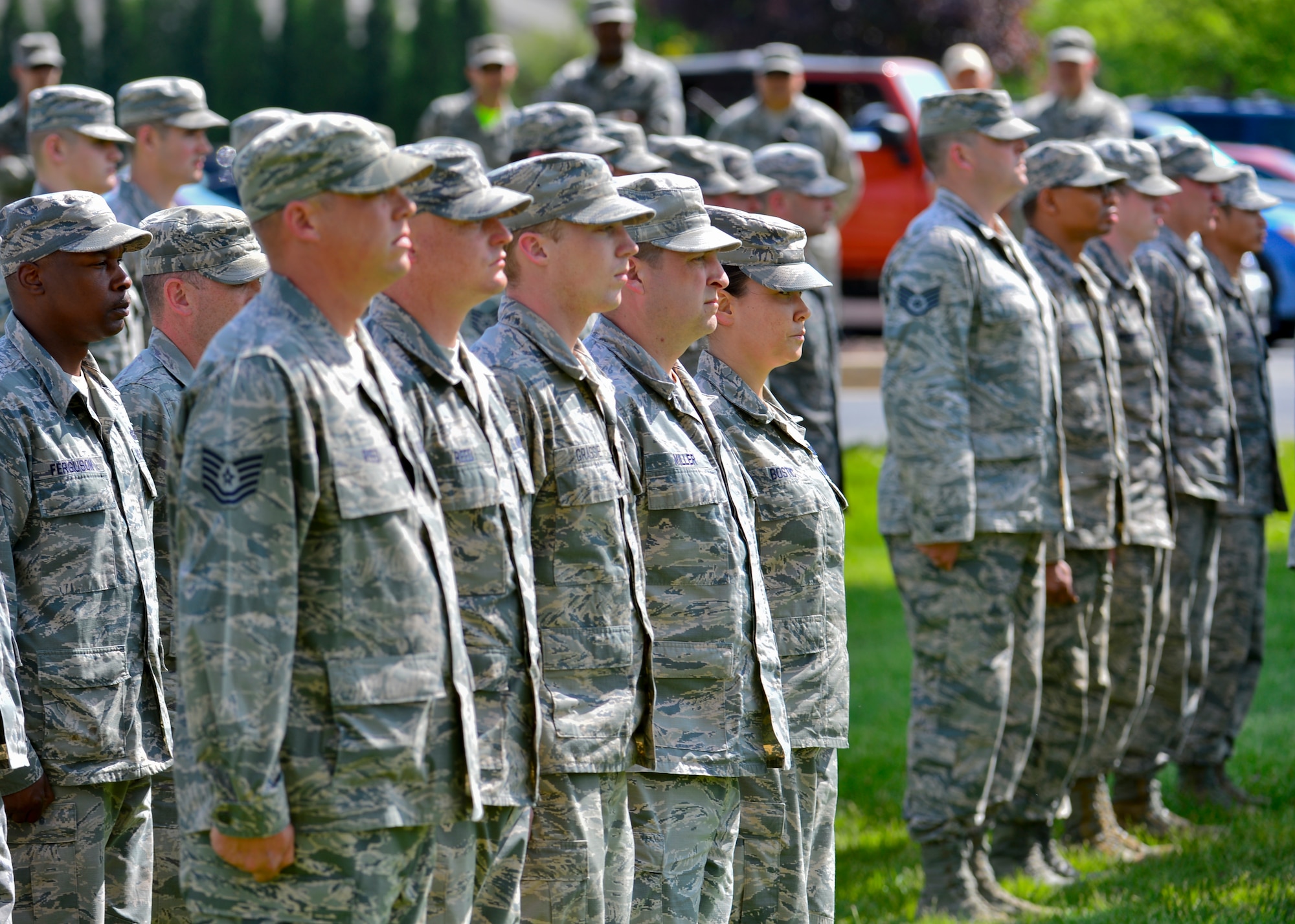 Airmen from the 436th Civil Engineer Squadron stand at attention during a retreat ceremony May 8, 2015, at Dover Air Force Base, Del. Retreat ceremonies are held every Friday during the summer months to signal the end of the official duty day and as a ceremony for paying respect to the flag. (U.S. Air Force photo/Airman 1st Class William Johnson)