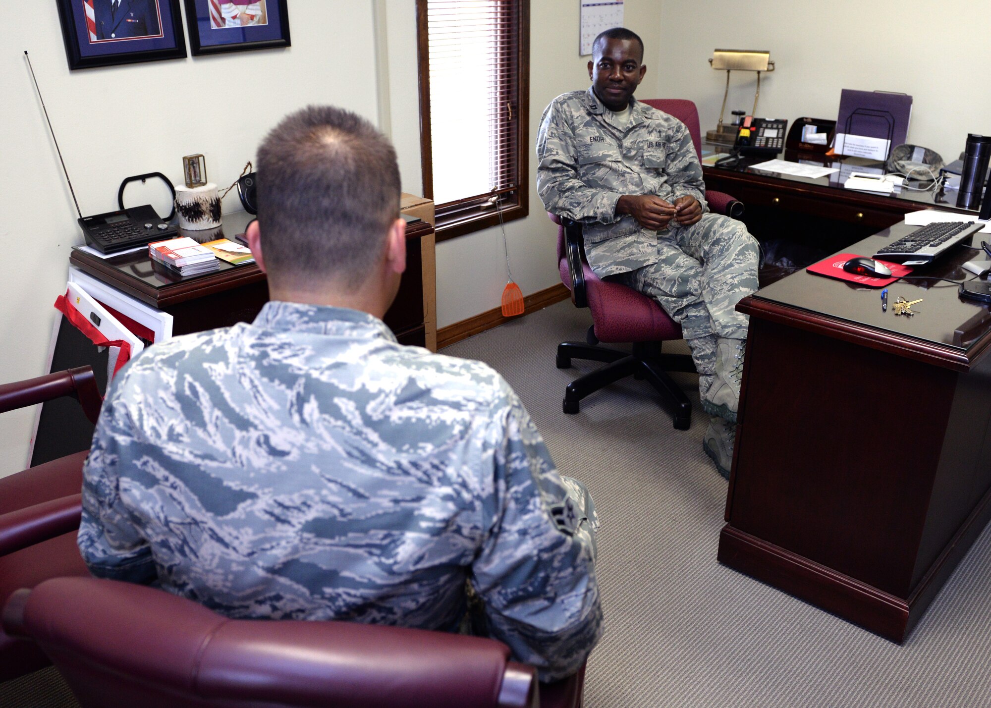 ALTUS AIR FORCE BASE, Okla. – U.S. Air Force 1st Lt. Emmanuel Enoh, 97th Air Mobility Wing chaplain, speaks with an Airman during a confidential counseling session at the chapel, May 7, 2015. Chaplains maintain a presence with the Airmen on base in a variety of ways, such as spiritual resilience retreats and base events, counseling services and squadron visits. (U.S. Air Force photo by Airman 1st Class Megan E. Acs/Released)