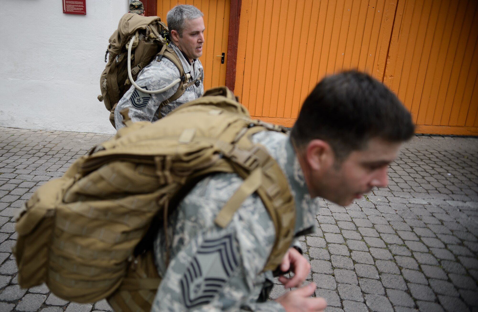 Master Sgt. Shawn Leonard, 4th Air Support Operations Group operations superintendent, left, and Chief Master Sgt. Richard Winegardner, 4th ASOG chief enlisted manager, run to the finish line May 1, 2015, at Undenheim, Germany. The Rhineland-Pfalz Reservist Chapter Undenheim hosted the 4th ASOG for a friendly ruck march. A German reservist finished in first place, with Winegardner coming in second and Leonard in third. (U.S. Air Force photo/Staff Sgt. Armando A. Schwier-Morales) 