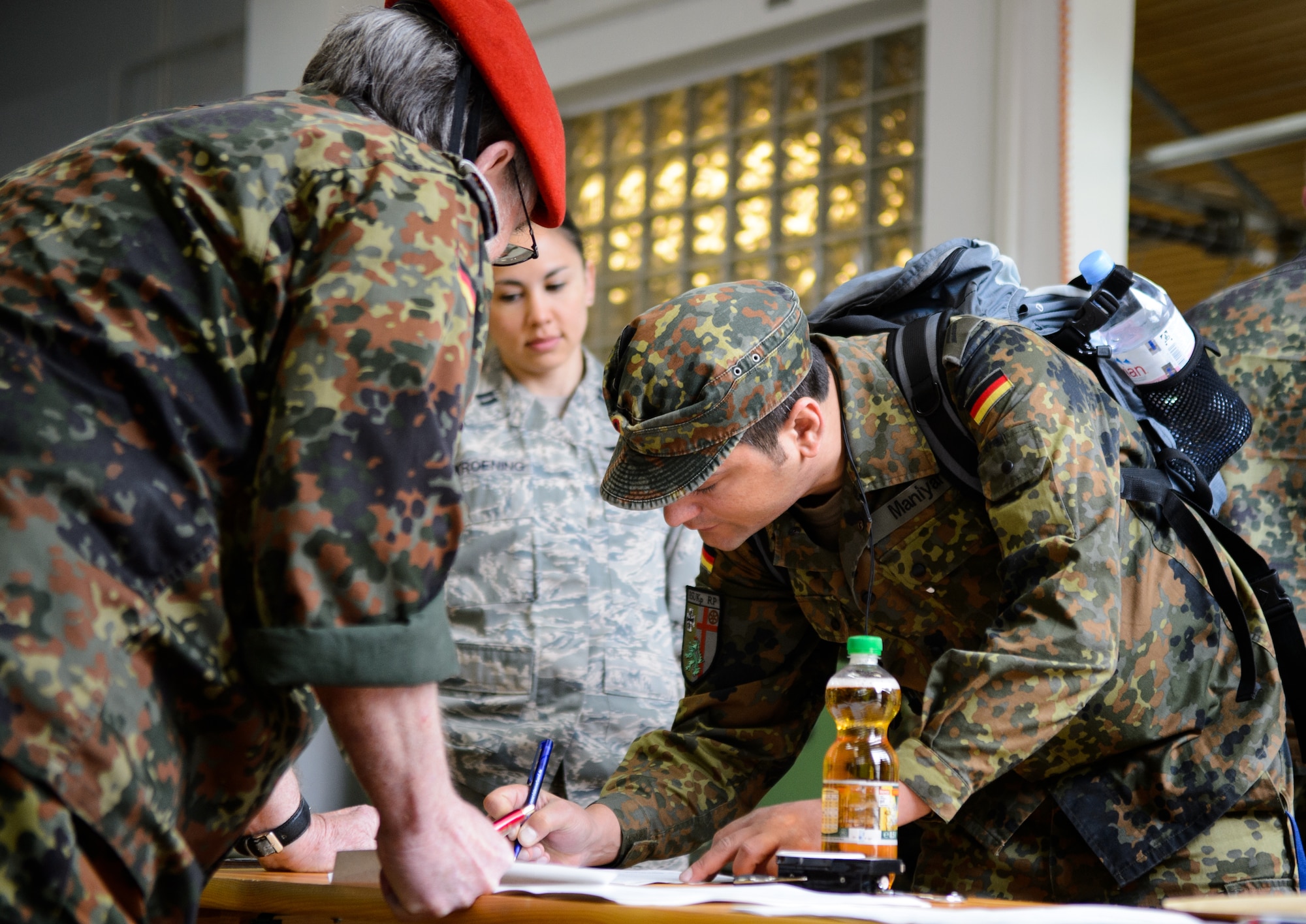 Capt. Sharon Kroening, 4th Air Support Operations Group air liaison officer, watches a German reservist sign up for a 12-kilometer ruck march May, 1, 2015, at Undenheim, Germany. Kroening and nine other Airmen joined the Rhineland-Pfalz Reservist Chapter Undenheim in the ruck march. (U.S. Air Force photo/Staff Sgt. Armando A. Schwier-Morales)