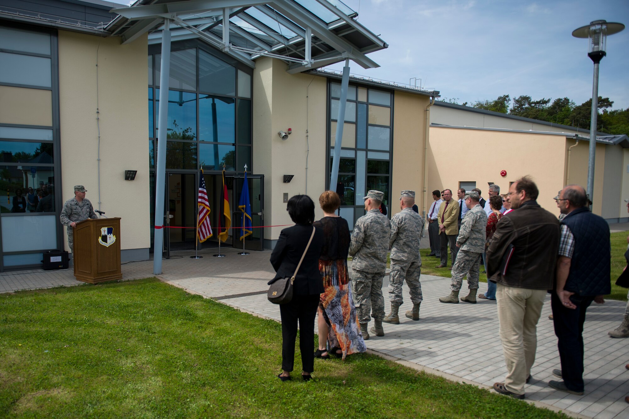 U.S. Air Force Col. Joe McFall, 52nd Fighter Wing commander, speaks to 52nd FW leadership and key community members during the official opening of the new child development center at Spangdahlem Air Base, Germany, May 11, 2015. More than 40 people were in attendance to celebrate the opening of the new facility. (U.S. Air Force photo by Airman 1st Class Luke Kitterman/Released)