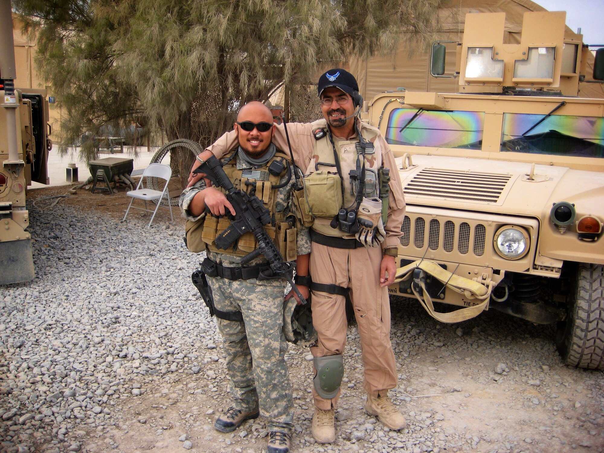 U.S. Air Force Special Agent Emmanuel Merhan, Air Force Office of Special Investigation, 4th Field Investigation Squadron, stands with his friend and interpreter Bashir while deployed to an undisclosed location. Merhan and Bashir were in Afghanistan to help improve the partnership with the local police. (Courtesy photo)