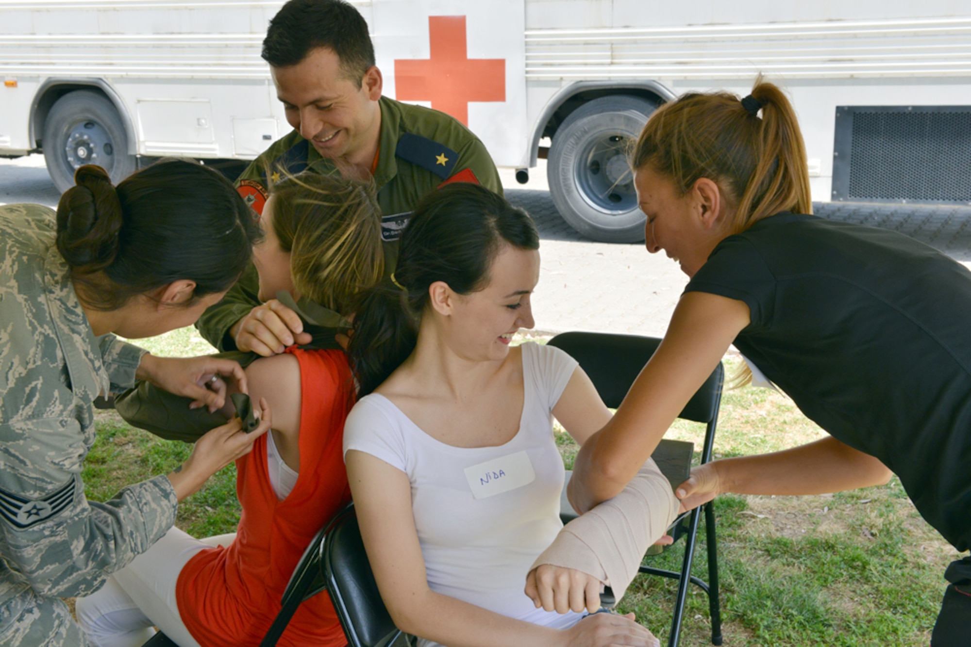 Participants of the 2015 Medical Rodeo bandage simulated patients at a medical station May 8, 2015, at Incirlik Air Base, Turkey.  The event was held in recognition of 2015 Nurse and Medical Technician Appreciation Week, which focused on this year’s theme "Nurses and Technicians: Leading the Way." (U.S. Air Force photo by Senior Airman Michael Battles/Released)