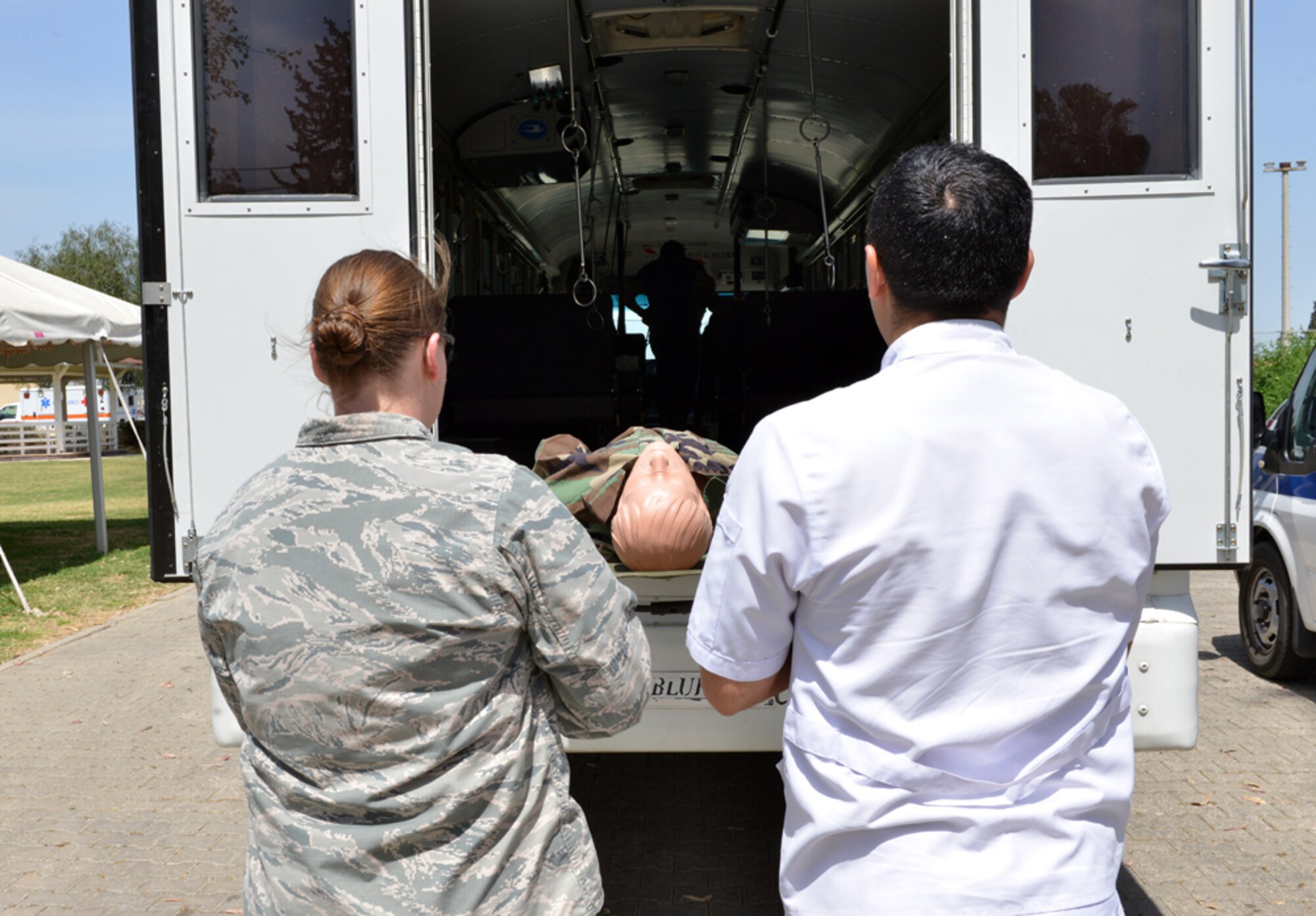 Maj. Cynthia Adams, 39th Medical Operations Squadron clinical medical flight commander, watches as a medical dummy is loaded onto an emergency vehicle during the 2015 Medical Rodeo May 8, 2015, at Incirlik Air Base, Turkey.  The event, which celebrated nurses and medical technicians, had participants from the U.S. and Turkish air forces, Spanish service members and nurses and technicians from the local community. (U.S. Air Force photo by Senior Airman Michael Battles/Released)