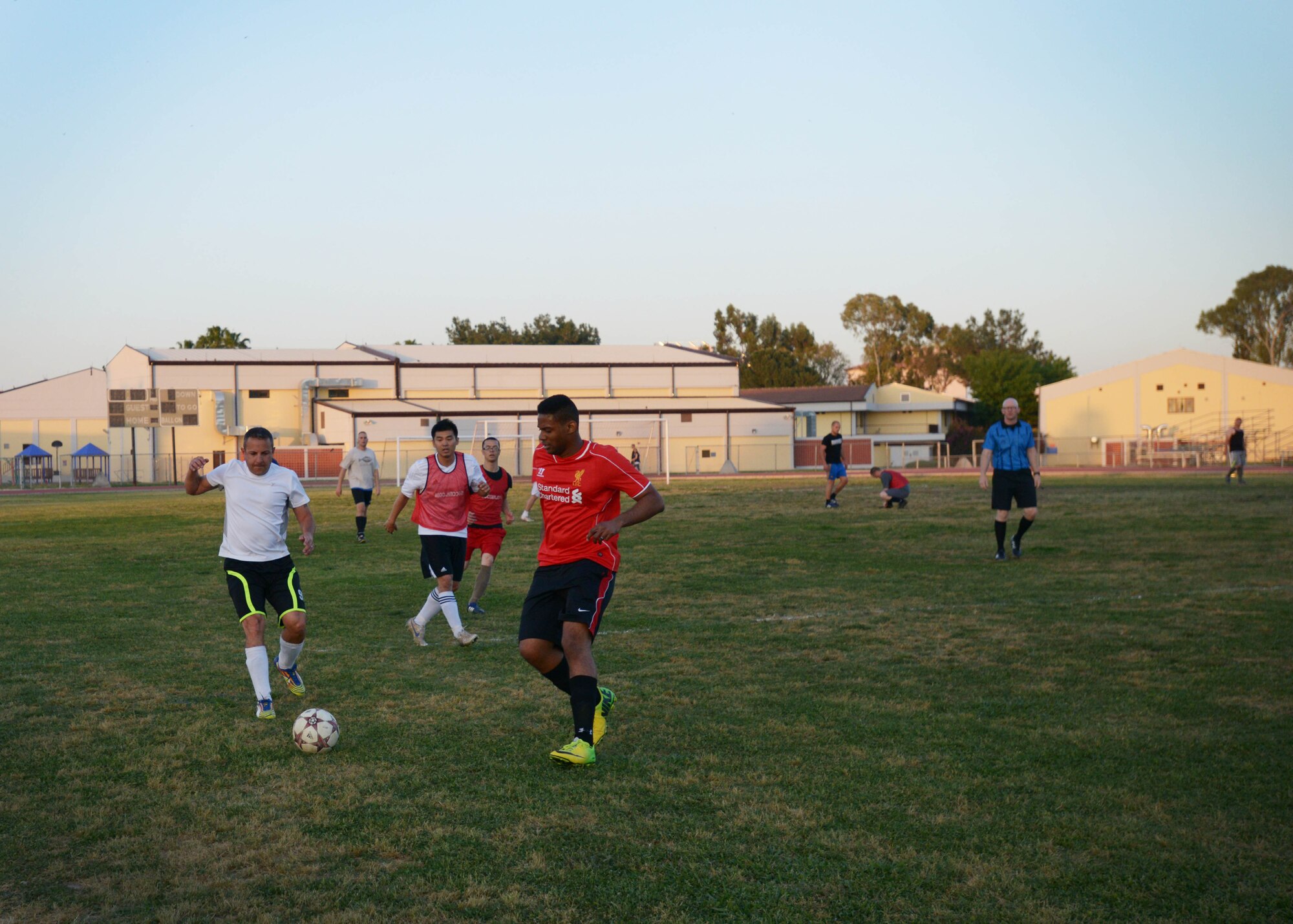 Players of the 60th Anniversary kick-off soccer game chase a soccer ball May 7, 2015, at Incirlik Air Base, Turkey. The players were composed of American, Turkish and Spanish personnel who played in mixed teams to celebrate 60 years of cooperation between the U.S. and Turkey. (U.S. Air Force photo by Senior Airman Krystal Ardrey/Released)