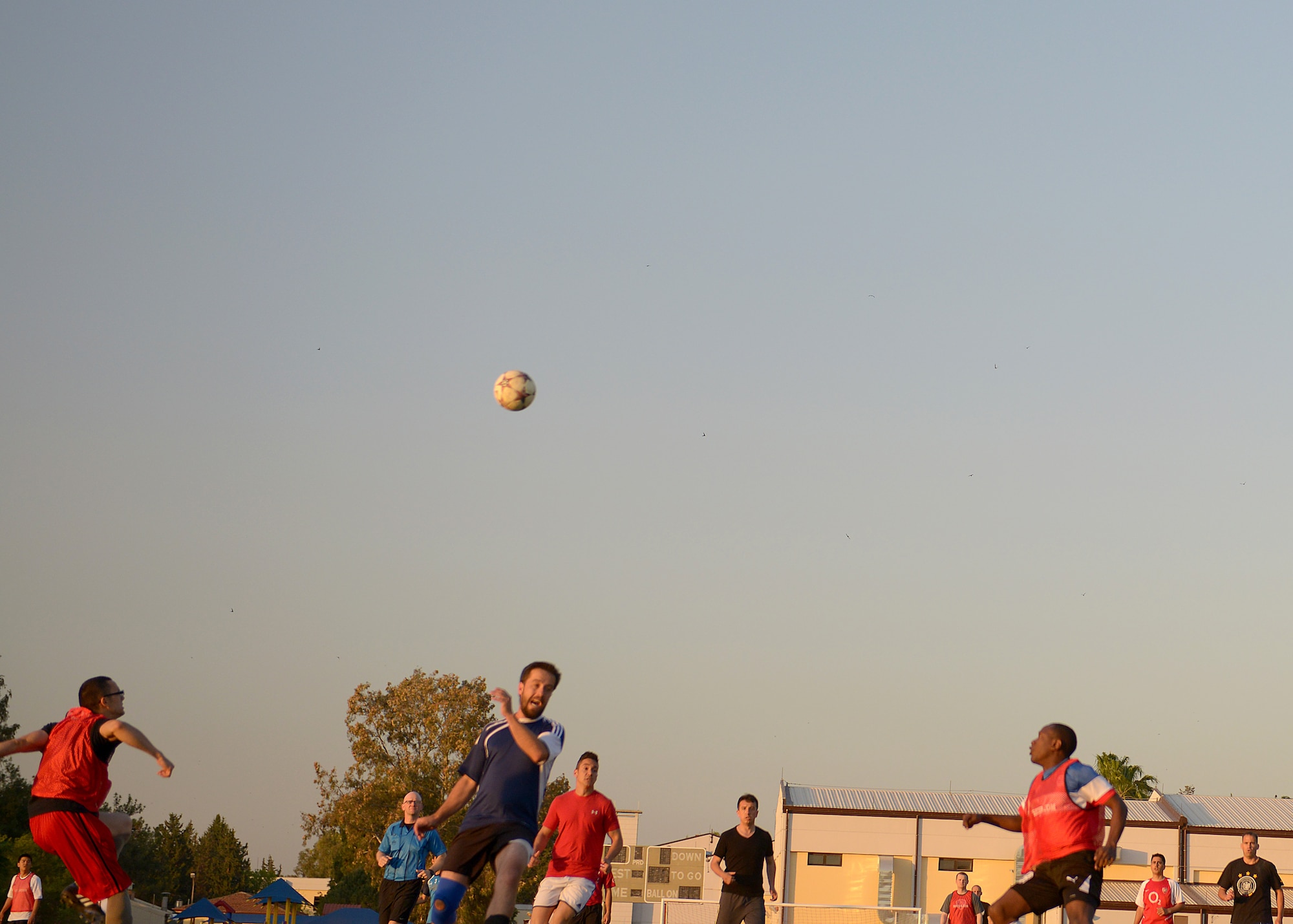 Soccer players run toward a ball during a 60th Anniversary kick-off soccer game May 7, 2015, at Incirlik Air Base, Turkey. The match, which was played by Americans, Turkish and Spanish players, celebrated 60 years of cooperation between the U.S. and Turkish air forces. (U.S. Air Force photo by Senior Airman Krystal Ardrey/Released)
