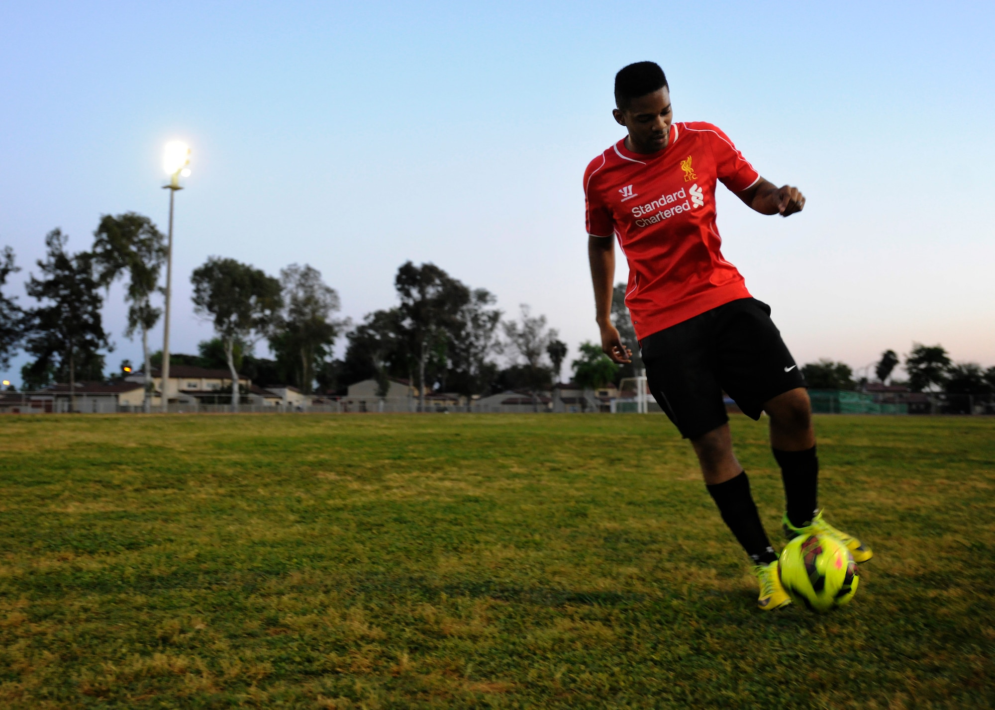 An Airman kicks a soccer ball during the 60th Anniversary kick-off soccer game, May 7, 2015, at Incirlik Air Base, Turkey. The soccer game was held in honor of the 60 year U.S. and Turkey partnership. (U.S. Air Force photo by Senior Airman Krystal Ardrey/Released) 