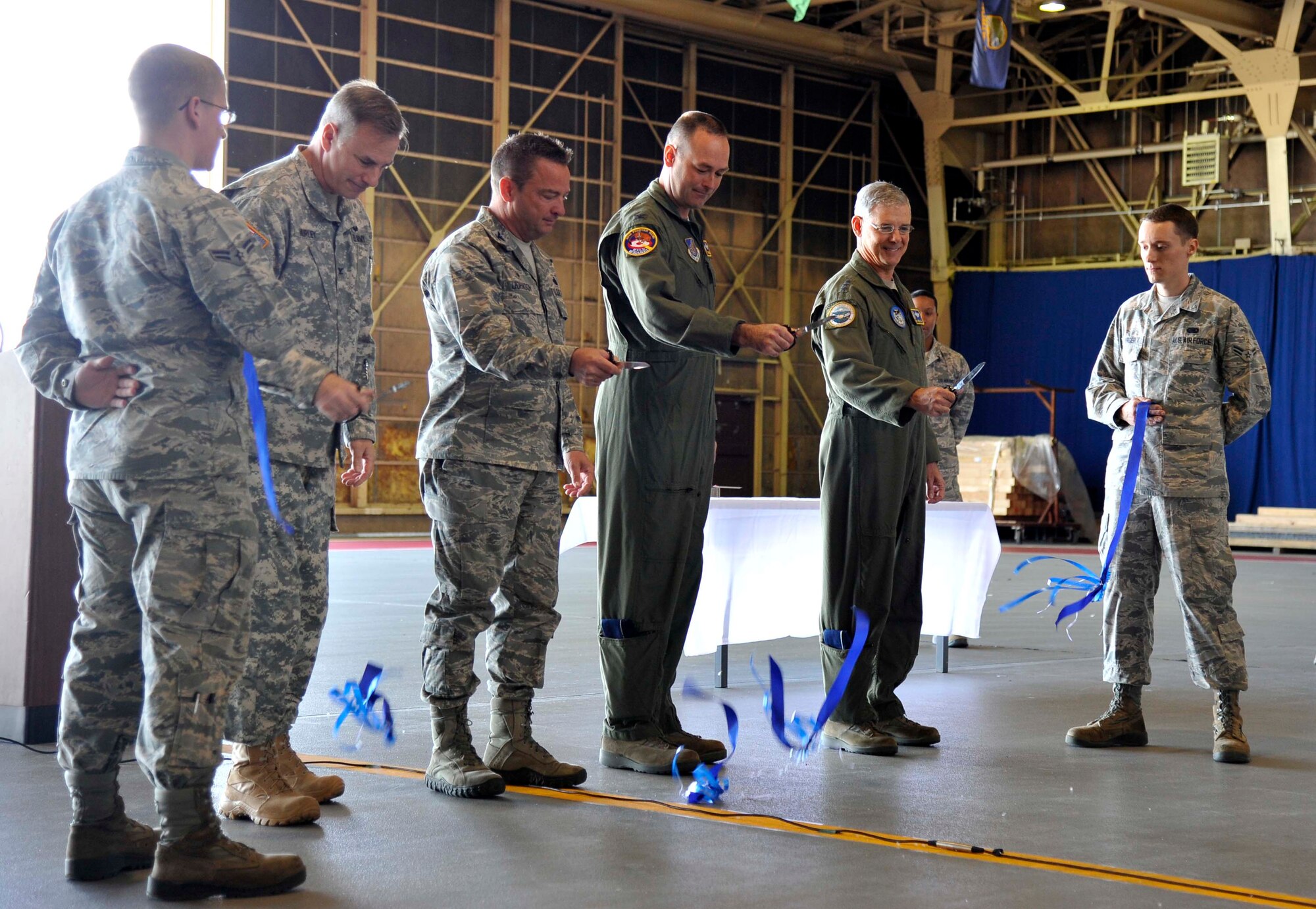 U.S. Air Force Lt. Gen. Sam Angelella, U.S. Forces Japan and 5th Air Force commander, conducts a ribbon cutting ceremony for the Type III Hydrant System alongside base leadership at Misawa Air Base, Japan, May 11, 2015. The hydrant system was constructed to allow Misawa the capability to host a larger fleet of aircraft more efficiently. This system was completed after a two-year process from planning to completion. (U.S. Air Force photo by Senior Airman Patrick Ciccarone/Released)
