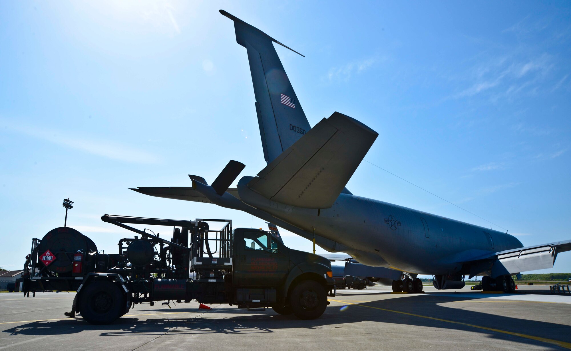 An R-12 fuel servicing truck approaches a KC-135 Stratotanker to conduct aircraft refueling at Misawa Air Base, Japan, May 11, 2015. The R-12 vehicles hook up to a newly installed Type III hydrant system and feeds fuel from underground tanks straight into the aircraft. (U.S. Air Force photo by Staff Sgt. Derek VanHorn)