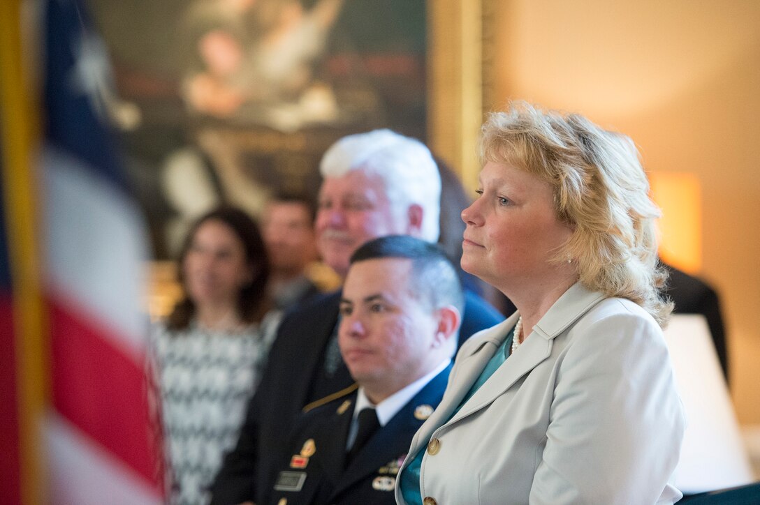 Mary Winnefeld listens as her husband, U.S. Navy Adm. James A. Winnefeld Jr., vice chairman of the Joint Chiefs of Staff, delivers remarks after receiving the French National Order of Merit, commander class, in Washington, D.C., May 11, 2015.