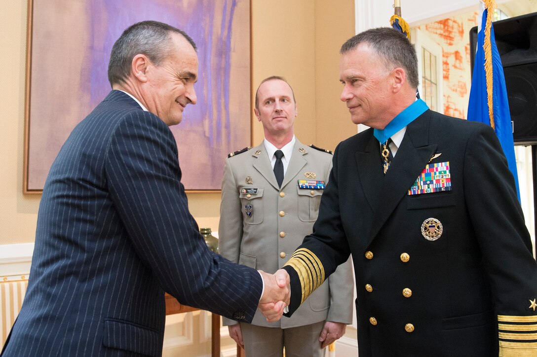 Gerard Araud, left, French ambassador to the United States, shakes hands with U.S. Navy Adm. James A. Winnefeld Jr., vice chairman of the Joint Chiefs of Staff, after presiding over the presentation of a National Order of Merit, commander class, to Winnefeld in Washington, D.C., May 11, 2015.