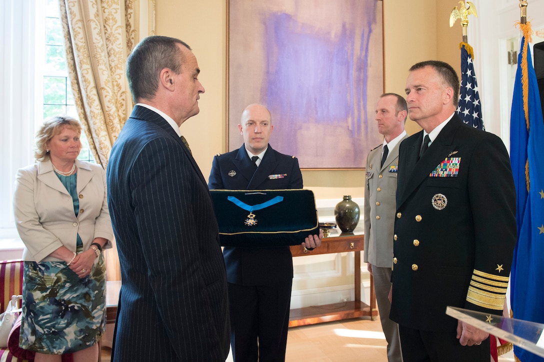 Gerard Araud, left center, the French ambassador to the U.S., prepares to present the National Order of Merit, commander class, to U.S. Navy Adm. James A. Winnefeld Jr., vice chairman of the Joint Chiefs of Staff, in Washington, D.C., May 11, 2015.