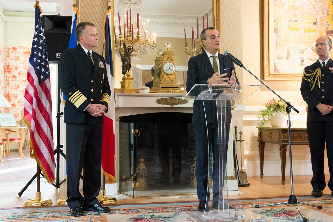 Gerard Araud, at lectern, French ambassador to the United States, delivers remarks before awarding U.S. Navy Adm. James A. Winnefeld Jr., vice chairman of the Joint Chiefs of Staff, the National Order of Merit, commander class, in Washington, D.C., May 11, 2015.