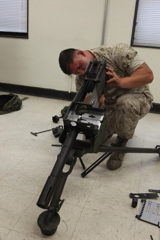 Lance Cpl. Christian Herbeck, a motor vehicle operator with 2nd Light Armored Reconnaissance Battalion, 2nd Marine Division, reassembles a Mk-19 automatic grenade launcher during a Machine Gunners Course at the Division Combat Skills Center aboard Camp Lejeune, N.C., April 15, 2015. During the course, the Marines were trained how to properly disassemble, reassemble and maintain the M249 squad automatic weapon, the M240B machine gun, Browning M2 .50 caliber machine gun and the MK19 automatic grenade launcher. (U.S. Marine Corps photo by Pfc. David N. Hersey/Released)