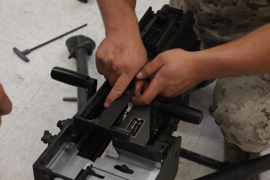 Lance Cpl. Christian Herbeck, a motor vehicle operator with 2nd Light Armored Reconnaissance Battalion, 2nd Marine Division, disassembles a Mk-19 automatic grenade launcher during a Machine Gunners Course at the Division Combat Skills Center aboard Camp Lejeune, N.C., April 15, 2015. During the course the Marines were trained how to properly disassemble, reassemble and maintain the M249 squad automatic weapon, the M240B machine gun, Browning M2 .50 caliber machine gun and the MK19 automatic grenade launcher. (U.S. Marine Corps photo by Pfc. David N. Hersey/Released)