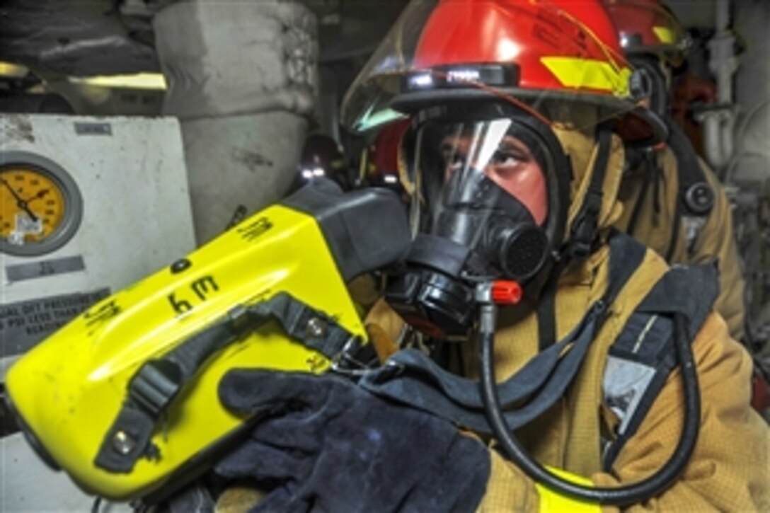 Navy Petty Officer 2nd Class Christian Karsemeyer uses a firefighting thermal imager during a fire drill aboard the amphibious assault ship USS Boxer in the Pacific Ocean, May 7, 2015. The Boxer is conducting routine training exercises and maintenance to prepare for its upcoming deployment. 