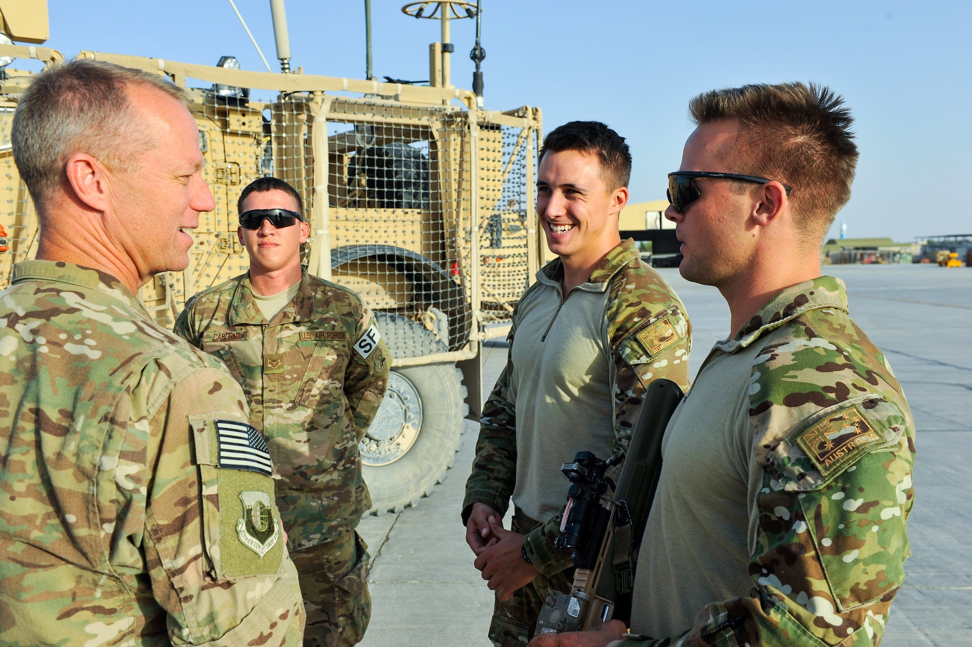 U.S. Air Force Brig. Gen. Mark D. Kelly, 455th Air Expeditionary Wing commander, talks with an Airman assigned to the 451st Security Forces Squadron and members of the Australian Defense Force during a visit to Kandahar Airfield, Afghanistan, May 2, 2015.  The general along with Chief Master Sgt. Jeffery Brown, 455th AEW command chief, met with Airmen from across the group who provide intelligence, surveillance and reconnaissance, command and control, personnel recovery, and airborne datalink capabilities to commanders in the Afghanistan theater of operations. (U.S. Air Force photo by Maj. Tony Wickman/Released)