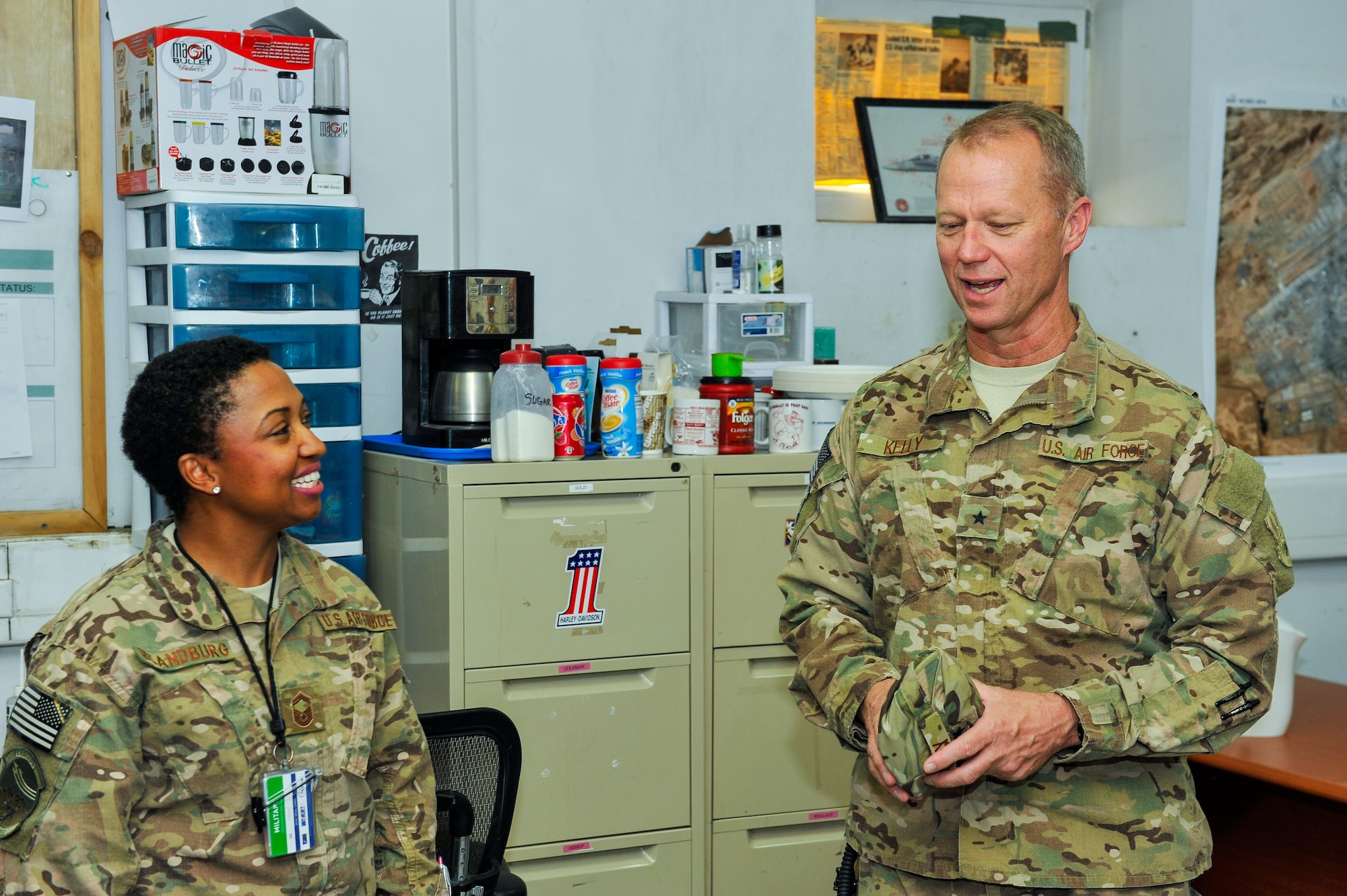 U.S. Air Force Brig. Gen. Mark D. Kelly, 455th Air Expeditionary Wing commander, talks with Senior Master Sgt. Cheronica Blandburg , 451st Air Expeditionary Group Command Post superintendent, during a visit to Kandahar Airfield, Afghanistan, May 3, 2015.  The general along with Chief Master Sgt. Jeffery Brown, 455th AEW command chief, met with Airmen from across the group who provide intelligence, surveillance and reconnaissance, command and control, personnel recovery, and airborne datalink capabilities to commanders in the Afghanistan theater of operations. (U.S. Air Force photo by Maj. Tony Wickman/Released)   