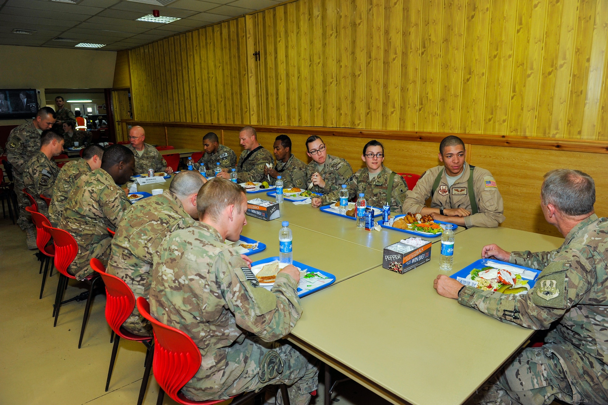 U.S. Air Force Brig. Gen. Mark D. Kelly, 455th Air Expeditionary Wing commander, and Chief Master Sgt. Jeffery Brown, 455th AEW command chief, eat lunch with Airmen assigned to the 451st Air Expeditionary Group during a visit to Kandahar Airfield, Afghanistan, May 3, 2015.  The general along with the chief met with Airmen from across the group who provide intelligence, surveillance and reconnaissance, command and control, personnel recovery, and airborne datalink capabilities to commanders in the Afghanistan theater of operations. (U.S. Air Force photo by Maj. Tony Wickman/Released)