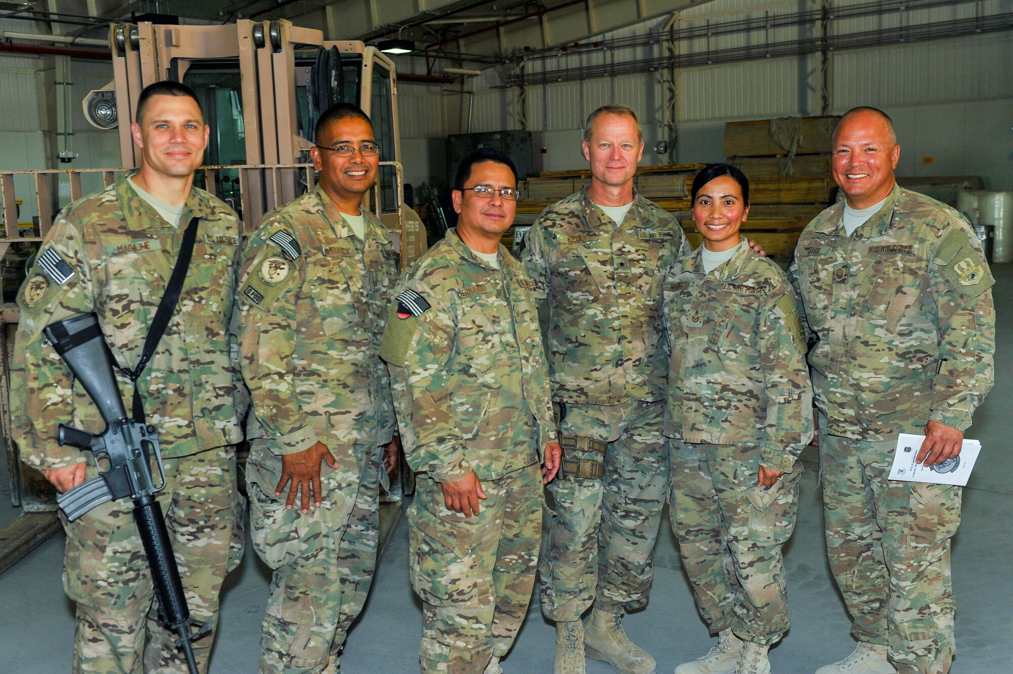 U.S. Air Force Brig. Gen. Mark D. Kelly, 455th Air Expeditionary Wing commander, takes a group photo with Airmen assigned to the 451st Air Expeditionary Group during a visit to Kandahar Airfield, Afghanistan, May 3, 2015.  The general along with Chief Master Sgt. Jeffery Brown, 455th AEW command chief, met with Airmen from across the group who provide intelligence, surveillance and reconnaissance, command and control, personnel recovery, and airborne datalink capabilities to commanders in the Afghanistan theater of operations. (U.S. Air Force photo by Maj. Tony Wickman/Released)