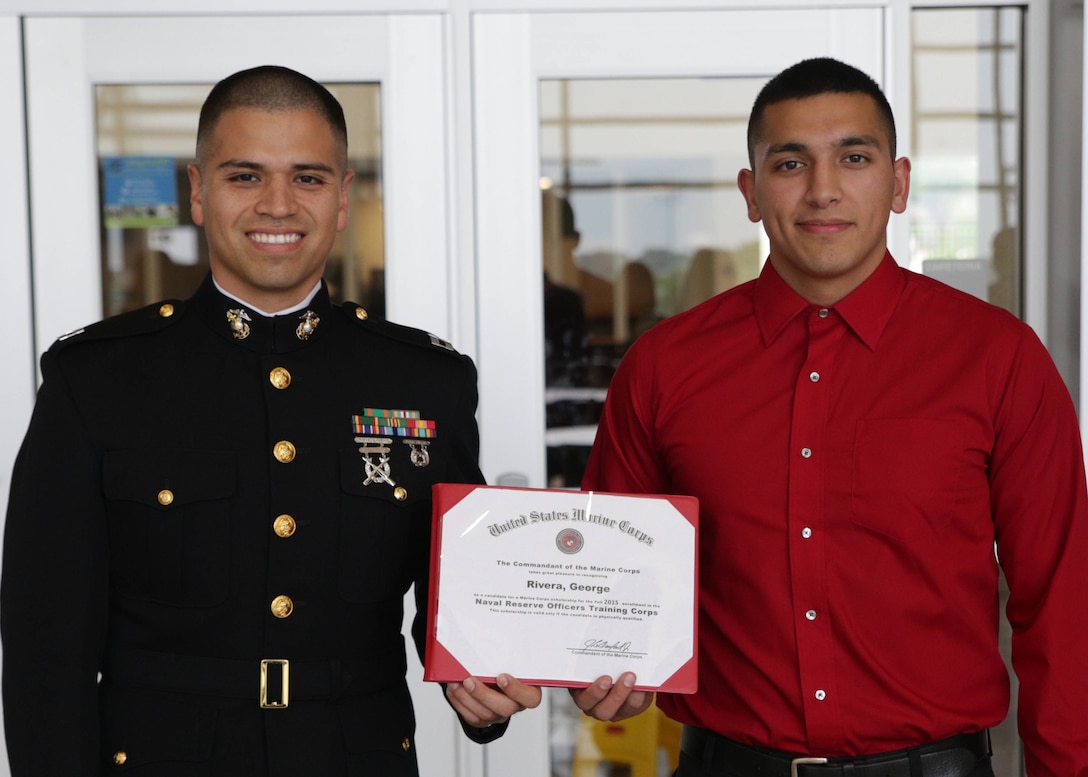 DESOTO, Texas - Capt. Yonic Medina presents a certificate awarding his
stepbrother, George Rivera the Naval Reserve Officer Training Corps
Scholarship for RS Dallas at Desoto High School May 11. Selected applicants
for the NROTC Scholarship Program are awarded scholarships through a highly
competitive national selection process, and receive full tuition, books
stipend, educational fees and other financial benefits at many of the
country's leading colleges and universities. Medina is the executive officer
of Recruiting Station San Antonio, 8th Marine Corps District, and Rivera is
a high school track and field athlete, slated to attend the University of
Houston in the fall. (U.S. Marine Corps photo by Cpl. Dustin Fugate)
