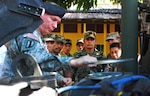 New Hampshire Army National Guard Chief Warrant Officer 4 Michael Tkacz disassembles the air filter of an 1165 High-Mobility Multi-Wheeled Vehicle with Salvadorian Army soldiers watching at the Salvadorian Calvary Regiment motor pool in La Libertad, El Salvador, Nov. 15, 2010.