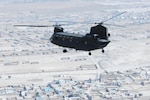 A 10th Combat Aviation Brigade CH-47 Chinook helicopter, operated by members of the Texas and Oklahoma National Guard, flies a personnel and equipment movement mission, Oct. 26, over Kabul, Afghanistan. A similar craft helped save stranded cattle on May 12, 2015.