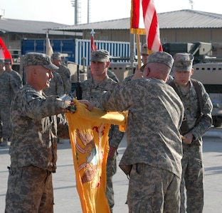 U.S. Army Command Sgt. Maj. John M. Montgomery, the Task Force Morgan command sergeant major, and U.S. Army Lt. Col. Timothy J. Murphy, the TF Morgan commander, roll up the 1st Squadron, 172nd Cavalry Squadron colors to take back to St. Albans, Vt., during the transfer of authority ceremony here Nov. 30, 2010.