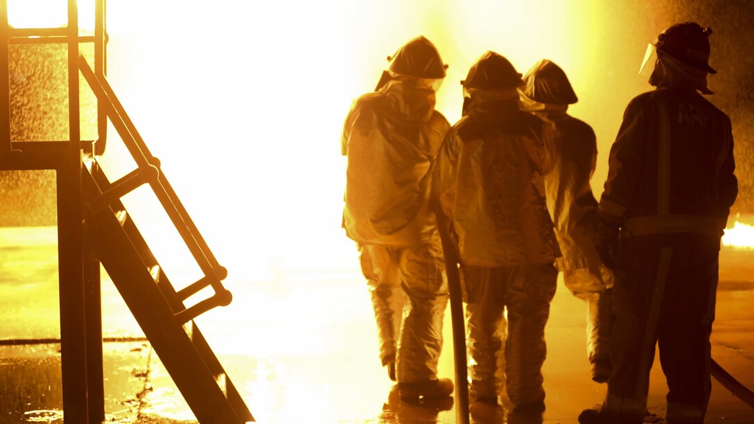 Marines with Marine Wing Support Squadron 171, Marine Rotational Force – Darwin, and their Australian counterparts with Aviation Rescue Firefighting Service, Airservices Australia, Darwin International Airport, practice extinguishing controlled chemical fires May 11 at RAFF Base Darwin, Darwin, Northern Territory, Australia. MWSS-171 is a part of the Marine Air - Ground Task Force that is composed of aviation, ground, and logistics combat elements, and lead by a command element, creating the MRF-D. The rotational deployment in Darwin enables Marines to more effectively train, exercise and operate with their partners, enhancing regional security and building a capacity to respond more rapidly to natural disasters and crises throughout that region. (U.S. Marine Corps photo by Cpl. Angel Serna/Released)