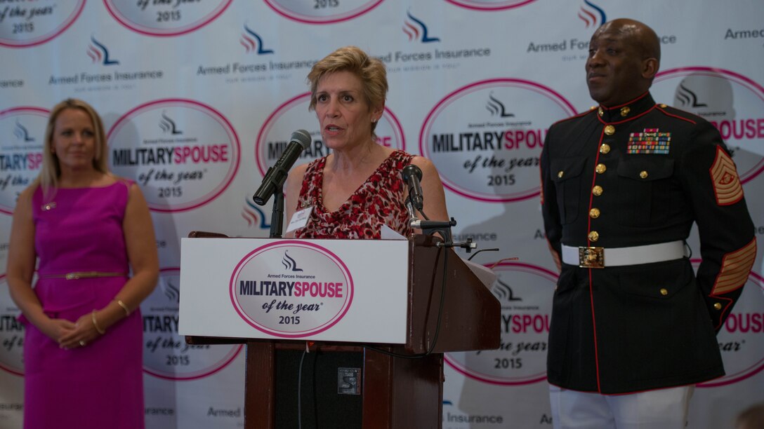 Ellyn Dunford, the wife of the 36th Commandant of the Marine Corps, and Sgt. Maj. Ronald Green, the 18th Sergeant Major of the Marine Corps, introduce Nicole Spaid the 2015 Armed Forces Insurance Marine Corps Spouse of the Year, at the 8th Annual Awards Luncheon at Joint Base Myer- Henderson Hall, May 8, 2015. Spaid was competing against five other spouses for the overall spouse of the year.