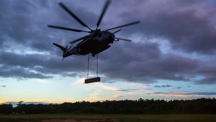 Marine pilots aboard a CH-53E Super Stallion helicopter with the 2nd Marine Aircraft Wing participate in an external lift exercise above Landing Zone Albatross aboard Marine Corps Base Camp Lejeune, N.C., May 7, 2015. The exercise was with the help of landing support specialists with Combat Logistics Battalion 22, Headquarters Regiment, and was intended to help both units maintain readiness for future operations that will require them to efficiently transport equipment and supplies. 