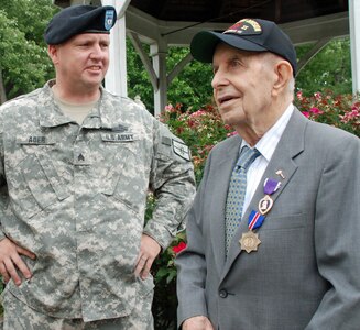 John Sidur, a veteran of the New York National Guard's 27th Infantry Division, visits with New York Army National Guard Sgt. James Ader earlier this year. Sidur will participate in a National Guard birthday celebration with the New York Guard today.