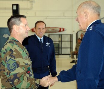 Air Force Lt. Gen. Harry W. Wyatt, the director of the Air National Guard, addressed nearly 100 members of the Colorado Air National Guard’s 140th Wing on Buckley Air Force Base in Aurora, Colo., Dec. 14, 2010. To begin the visit, Wyatt presented challenge coins to Master Sgt. Evan Fenn, who was named Air Force Crew Chief of the Year, and Maj. Mike Gommel for his demonstrated excellence.