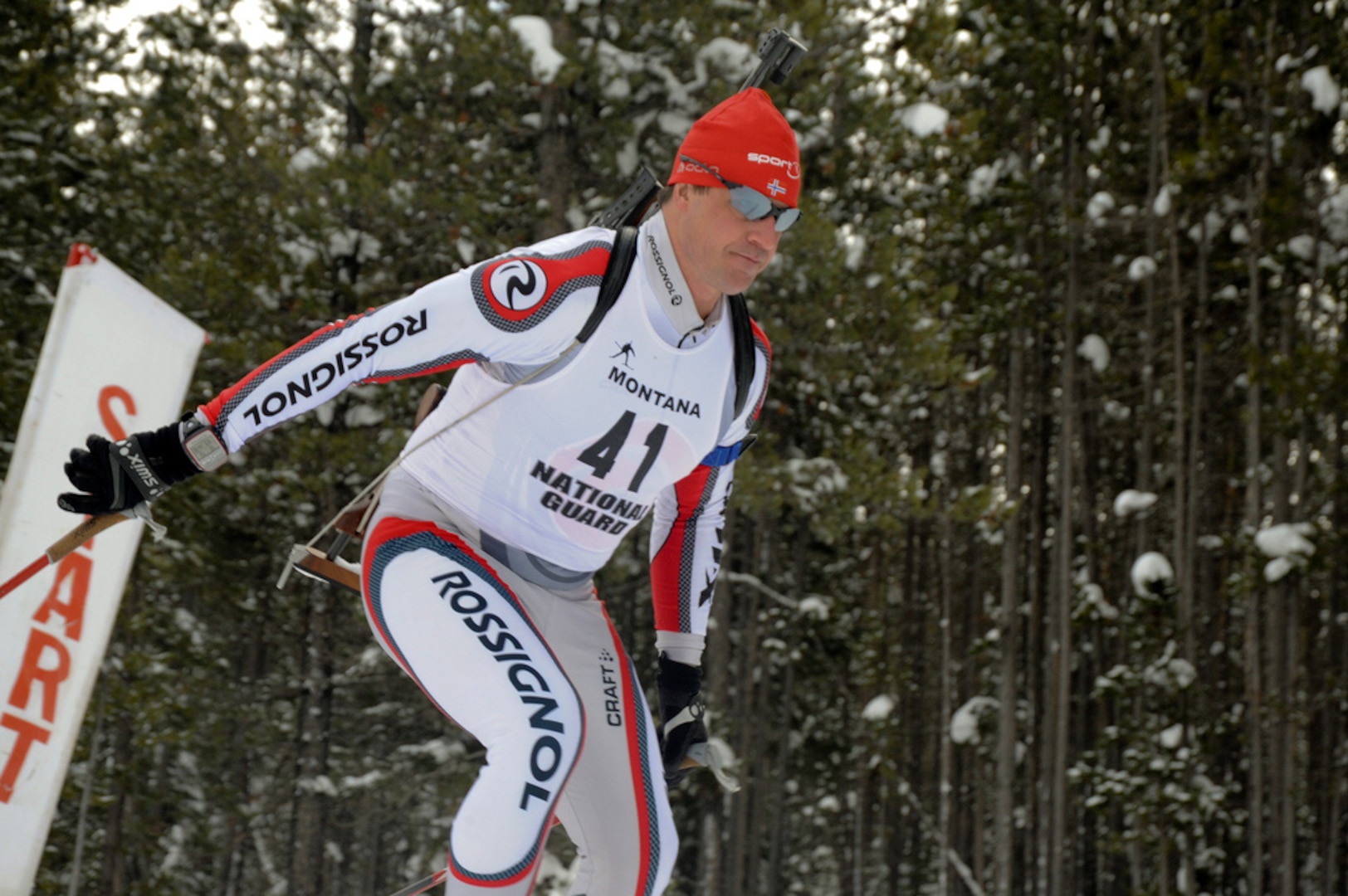 Army Spc. Andy Wilkens, Colorado National Guard Biathlon coordinator, crosses the starting line of a practice on day four of the National Guard Biathlon All Regions Snow Camp Dec. 11, 2010, in West Yellowstone, Mont. The 6-kilometer practice race challenged the racers to apply all of the skills they learned during the camp over the first three days. "This was an open door training event for the purpose of presenting the sport of biathlon to the individual National Guard states, said Wilkens. The four-day event covered everything from basic skiing techniques to competitive marksmanship and offered a greater number of Soldiers and Airmen the opportunity to participate in instruction generally only available to national-level athletes.