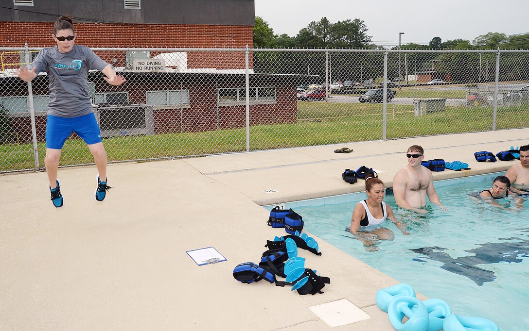 Whitney Hendrix, Aquatics Maximum Power-Intense Training instructor, Marine Corps Community Services, demonstrates a physical fitness move during training, May 13, for a group of Marines who will become future AMP-IT instructors and be able to train their Marines on the exercises.