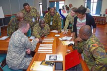 LAE, Papua New Guinea (May 11, 2105) - Participants discuss the best options in responding to a mock disaster during a working group at the Oceania Pacific Resilience Disaster Response Exercise and Exchange (DREE) held. The DREE is a five-day exercise, hosted by the Papua New Guinea Defense Force, that will consist of presentations and discussions from subject matter experts, a tabletop exercise, a field training exercise and an after action review.  