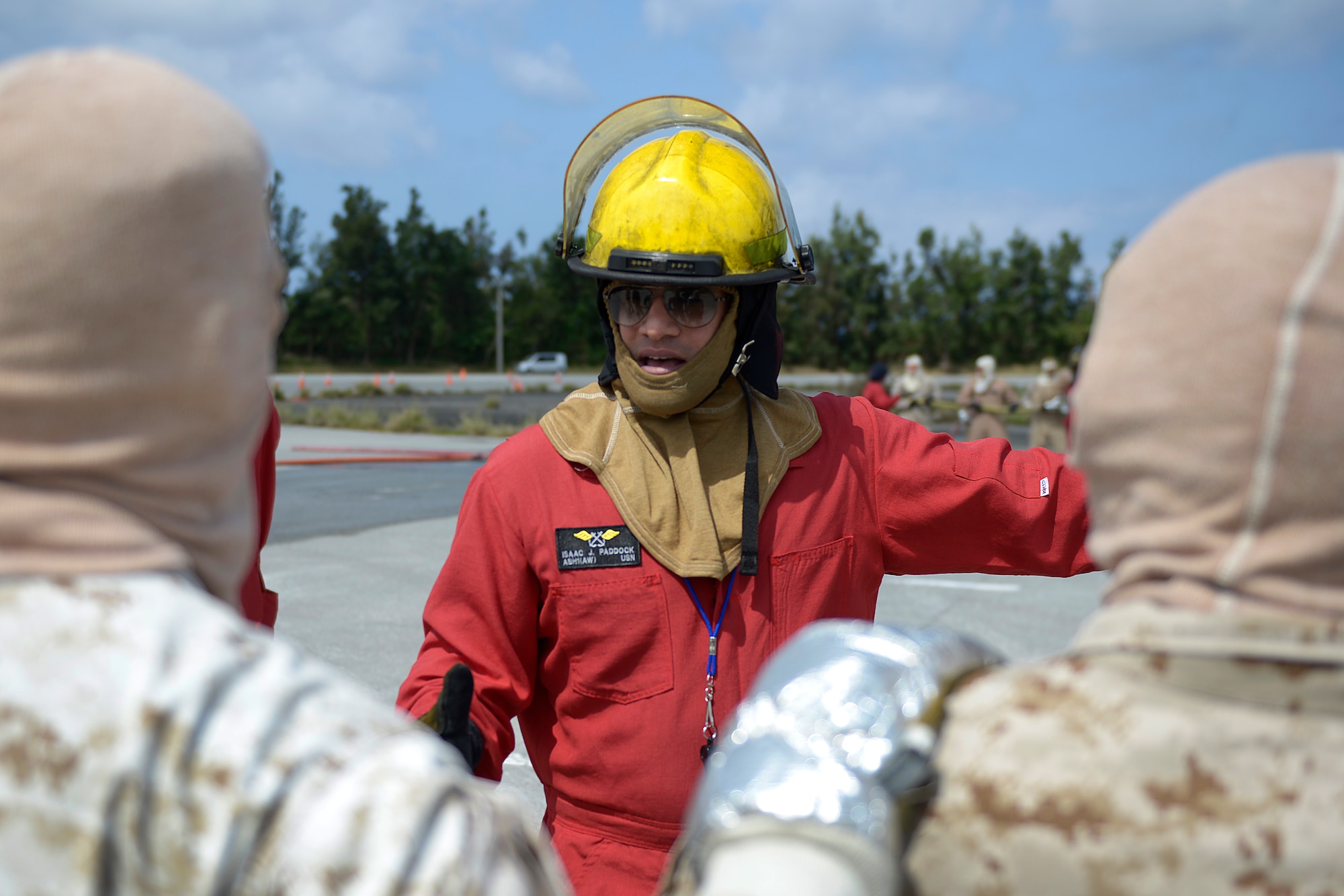 A U.S. Navy Petty Officer 1st Class Isaac Paddock, shipboard firefighting instructor, instructs U.S. Marines from the 31st Marine Expeditionary Wing on Marine Corps Air Station Futenma, Japan, at an aircraft fire simulator on Kadena Air Base, Japan, May 8, 2015. To prepare for shipboard deployments, every Marine and sailor must meet training qualifications. This is the first time in recent history Navy firefighting instructors have used Kadena’s facilities to teach roughly 150 Marines from the 31st Marine Expeditionary Wing during a training course here May 4-8 to ensure they’re prepared for their upcoming deployment. (U.S. Air Force photo by Staff Sgt. Maeson L. Elleman)