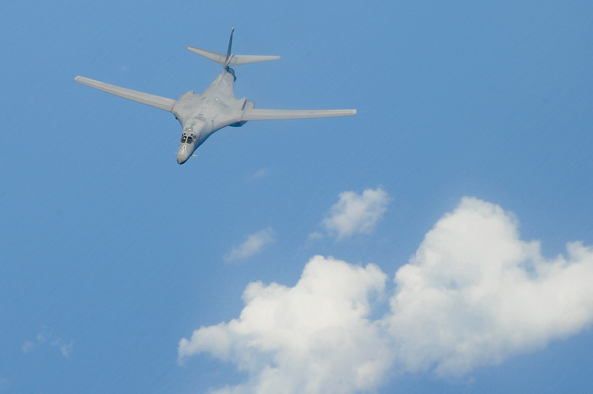A U.S. Air Force B-1B Lancer bomber belonging to Dyess Air Force Base, Texas, flies through the sky after refueling during a training sortie involving aircraft from Dyess and Kadena Air Base, Japan, May 8, 2015. During this training, a Kadena-based KC-135 Stratotanker from the 909th Air Refueling Squadron traveled to Guam to allow crews from both aircraft to practice refueling procedures. (U.S. Air Force photo by Tech. Sgt. Darnell T. Cannady)