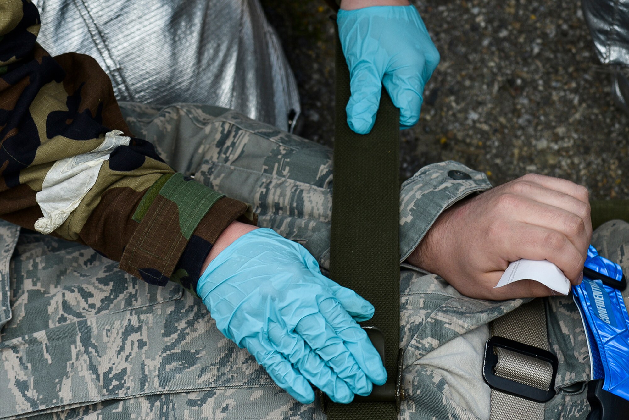 An airman is strapped onto a stretcher before being taken to an ambulance during a simulated mass casualty exercise May 12, 2015, at Osan Air Base, Republic of Korea. The simulations were part of operational readiness exercise Beverly Midnight 15-02, one of the quarterly OREs conducted by Team Osan. (U.S. Air Force photo by Staff Sgt. Jake Barreiro/Released)