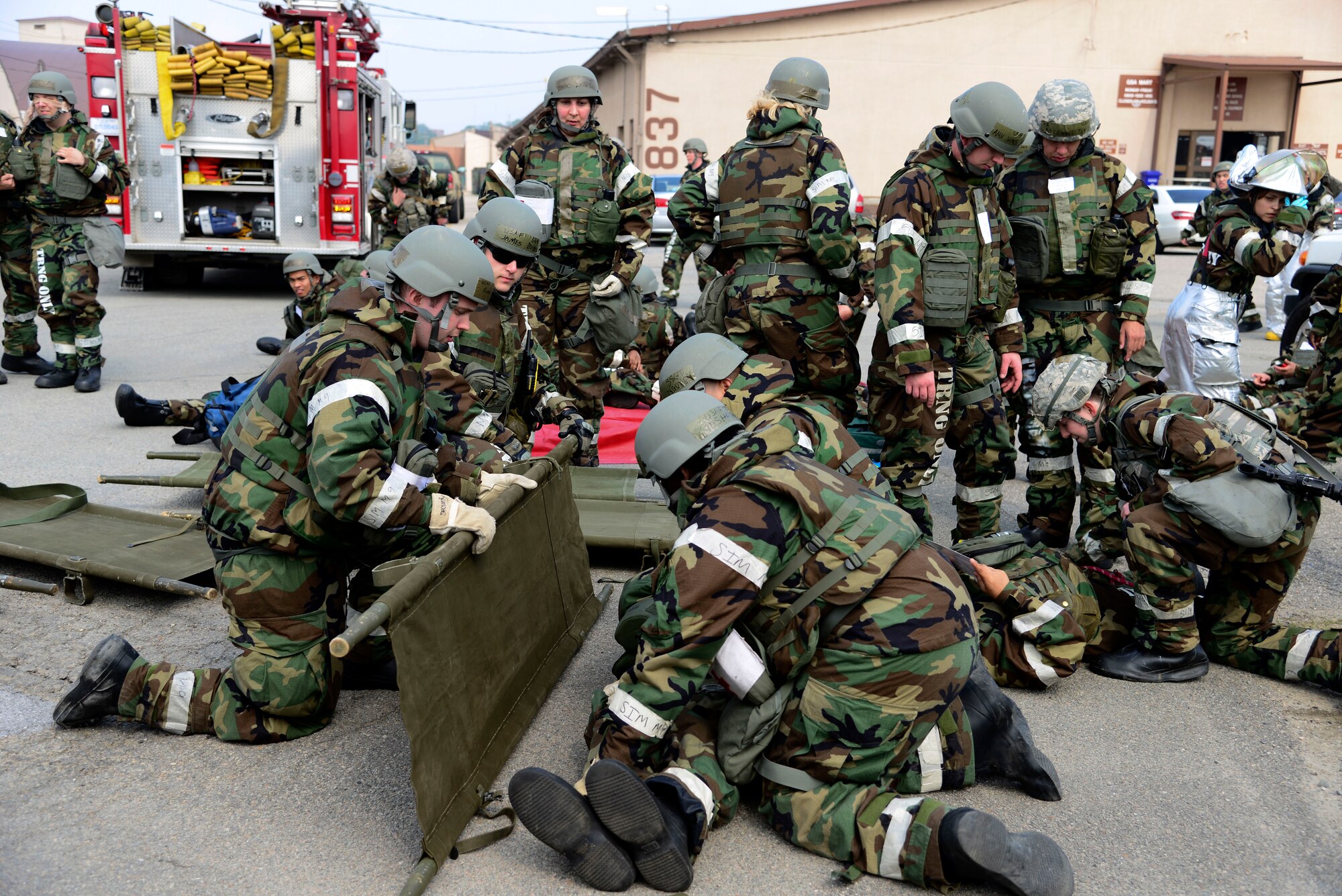 Medical Airman put casualties onto litters in a mass casualty exercise during Beverly Midnight 15-2 May 12, 2015 at Osan Air Base, Republic of Korea. The exercise focuses on readiness, testing Osan’s wartime procedures, and realistically looking at our ability to defend the base, execute operations and receive follow-on forces. (U.S. Air Force photo by Senior Airman Matthew Lancaster)