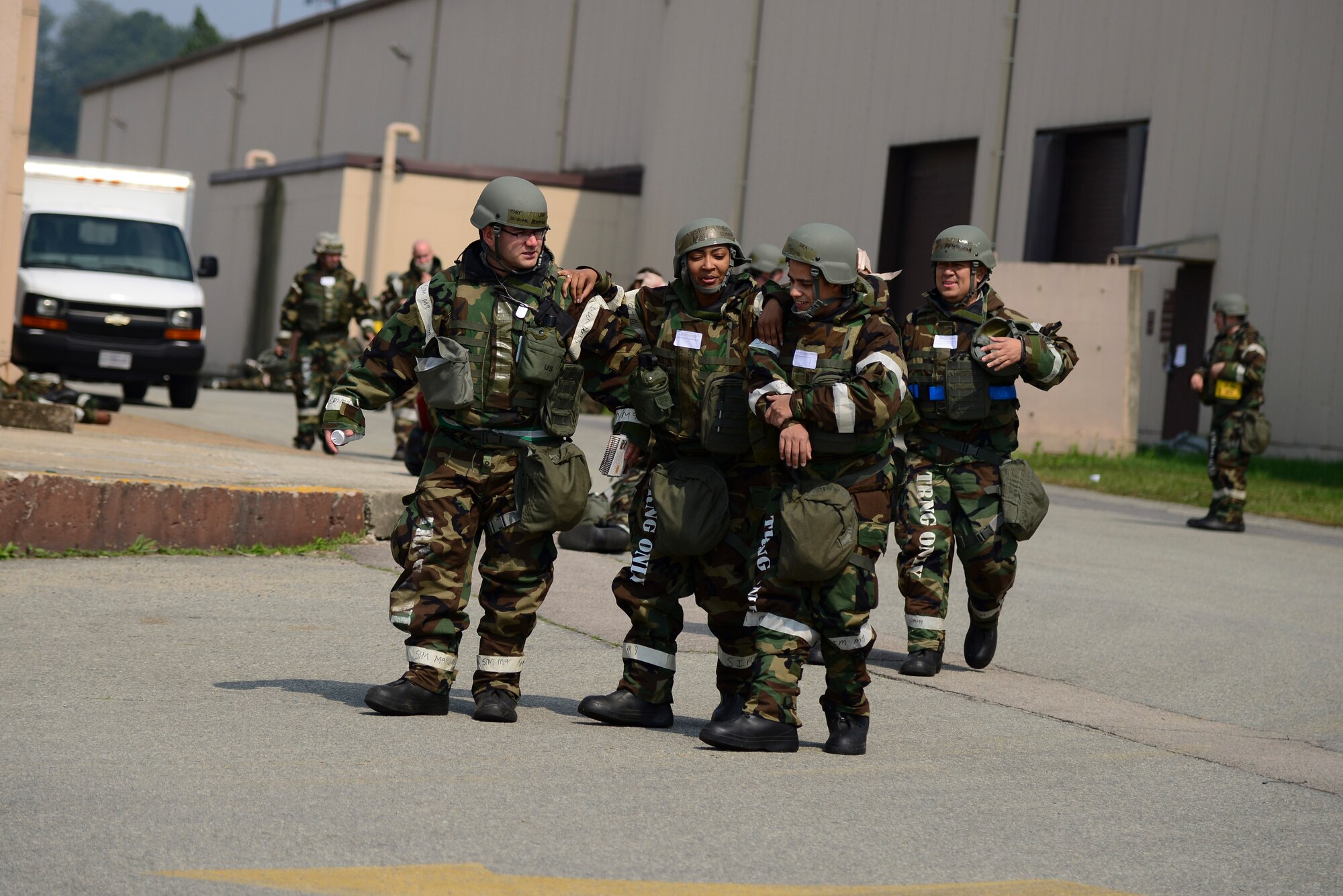 Airmen move the injured closer the ambulance in a mass casualty exercise during Beverly Midnight 15-2 May 12, 2015 at Osan Air Base, Republic of Korea.The exercise focuses on readiness, testing Osan’s wartime procedures, and realistically looking at our ability to defend the base, execute operations and receive follow-on forces. (U.S. Air Force photo by Senior Airman Matthew Lancaster)