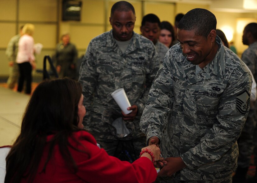 Master Sgt. Kingsley Scott, 319th Air Base Wing career assistance advisor, shakes hands with Ellie Kay, consumer finance consultant and best-selling author, at the Heroes at Home event May, 12 2015 at the Northern Lights Club on Grand Forks Air Force Base. Heroes at Home is a financial education tour sponsored by USAA. Grand Forks Air Force Base was one of six bases visited by Kay and her team. (U.S. Air Force photo by Airman 1st Class Ryan Sparks/released)