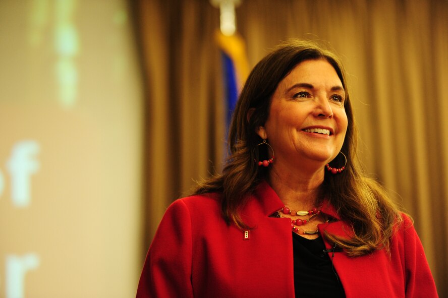 Ellie Kay, consumer finance consultant and best-selling author, smiles during her speech for the Heroes at Home event May, 12 2015 at the Northern Lights Club on Grand Forks Air Force Base. Heroes at Home is a financial education tour sponsored by USAA. Grand Forks Air Force Base was one of six bases visited by Kay and her team. (U.S. Air Force photo by Airman 1st Class Ryan Sparks/released)