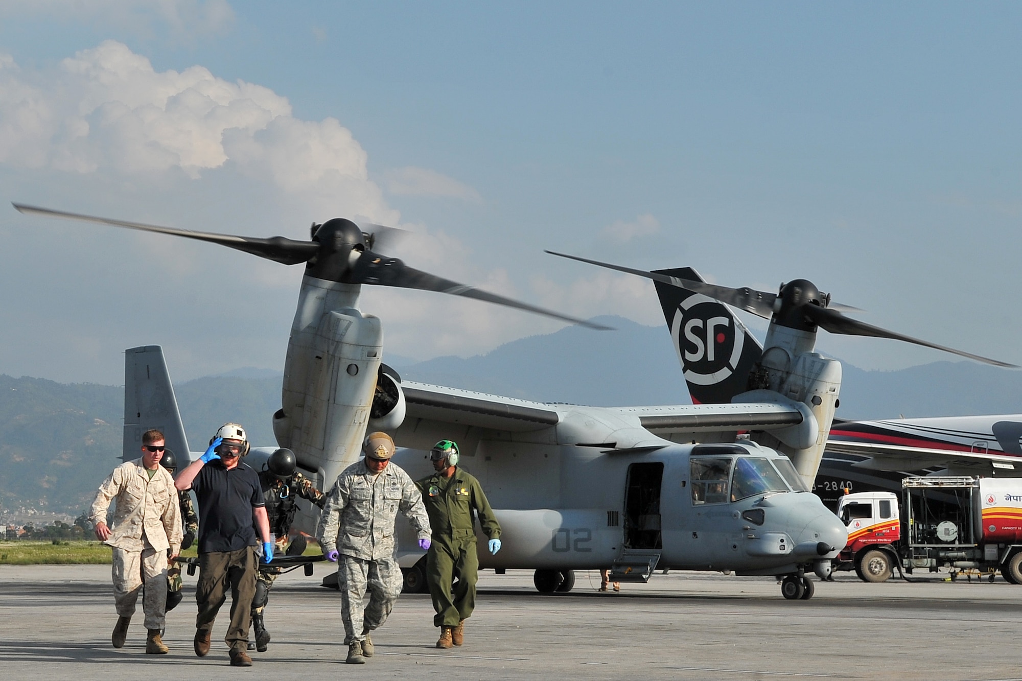 U.S. Air Force, Marines, and Nepalese army members transport an earthquake patient from a MV-22 Osprey for medical care at the Tribhuvan International Airport in Kathmandu, Nepal, May 12, 2015. The Joint Task Force-505 members worked with the Nepalese army to triage, treat and transport patients after a 7.3 magnitude earthquake struck the same day following a 7.8 magnitude quake that devastated the nation April 25, 2015. (U.S. Air Force photo by Staff Sgt. Melissa B. White/Released)
