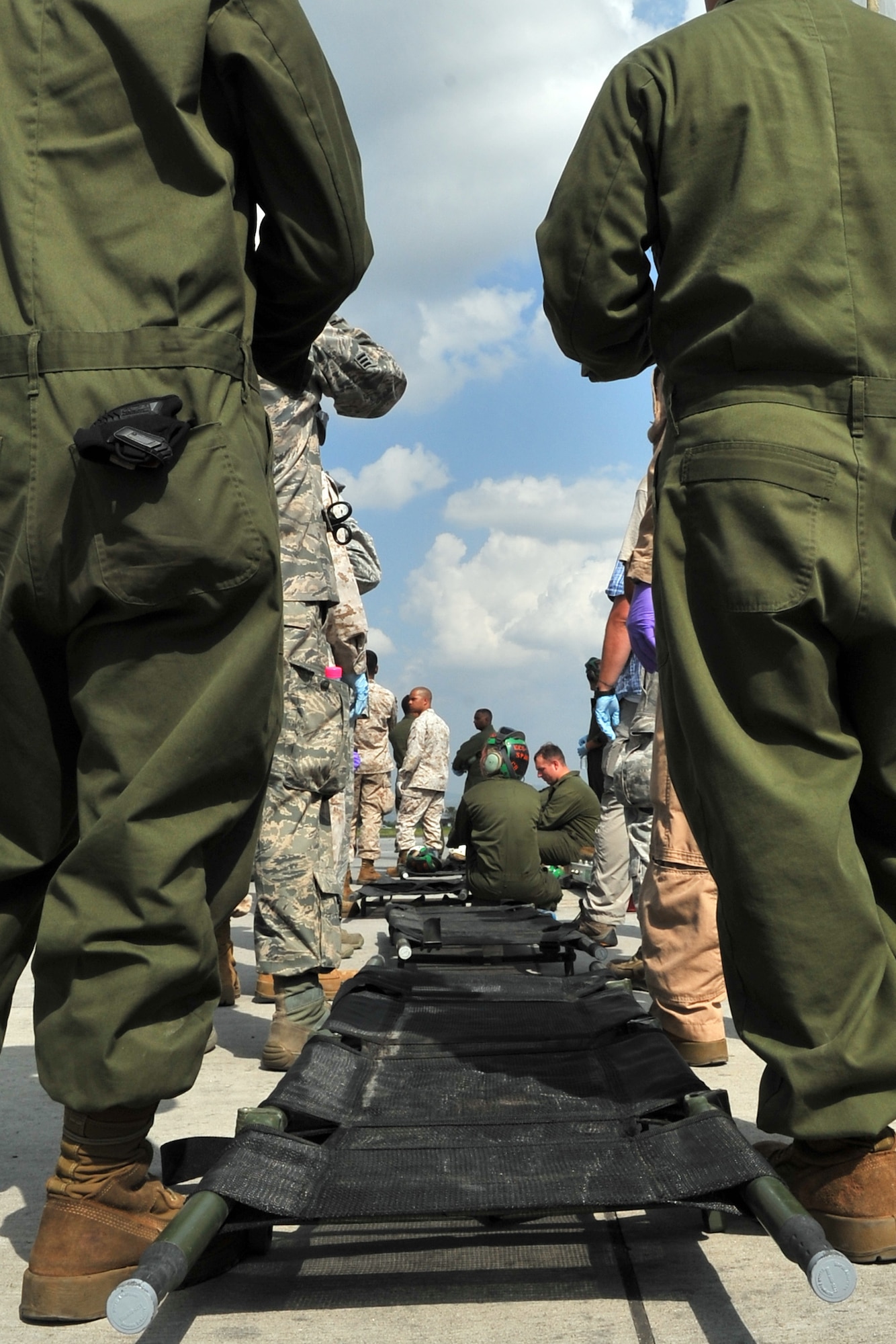 U.S. Marines and Airmen standby with litters to transport earthquake victims at the Tribhuvan International Airport in Kathmandu, Nepal, May 12, 2015. Joint Task Force-505 members worked with the Nepalese army to triage, treat and transport patients after a 7.3 magnitude earthquake struck the same day following a 7.8 magnitude quake that devastated the nation April 25, 2015. (U.S. Air Force photo by Staff Sgt. Melissa B. White/Released)