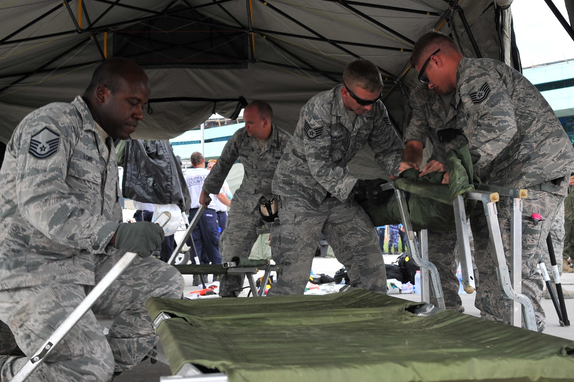 U.S. Airmen assigned to 36th Contingency Response Group set up a flightline aid station for medical professionals to take care of earthquake victims at the Tribhuvan International Airport in Kathmandu, Nepal, May 12, 2015. Joint Task Force-505 members worked with the Nepalese army to triage, treat and transport patients after a 7.3 magnitude earthquake struck the same day following a 7.8 magnitude earthquake that devastated the nation April 25, 2015. (U.S. Air Force photo by Staff Sgt. Melissa B. White/Released)