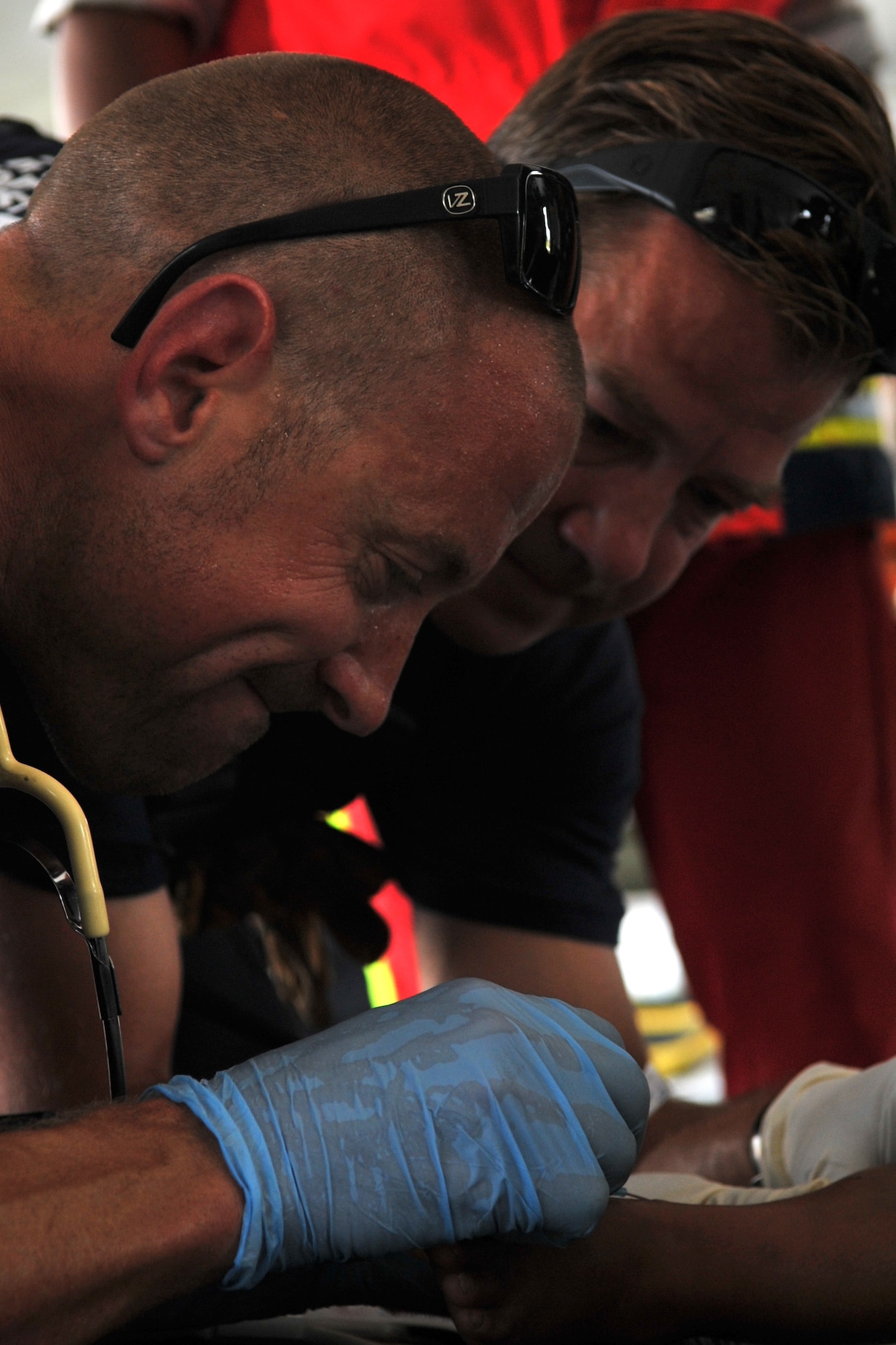 J.P. Reardon (left) and Steve Strott, both U.S. Agency for International Development firefighter paramedics, treat an earthquake victim at the Tribhuvan International Airport in Kathmandu, Nepal, May 12, 2015. Joint Task Force-505 and USAID members worked with the Nepalese army to triage, treat and transport patients after a 7.3 magnitude earthquake struck the same day following a 7.8 magnitude earthquake that devastated the nation April 25, 2015. (U.S. Air Force photo by Staff Sgt. Melissa B. White/Released)